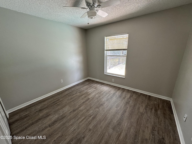 539 Olsmar St SW, Palm Bay, FL 32908 - spare room with dark wood-style floors, a textured ceiling, a ceiling fan, and baseboards