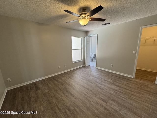 539 Olsmar St SW, Palm Bay, FL 32908 - spare room featuring dark wood finished floors, a ceiling fan, a textured ceiling, and baseboards