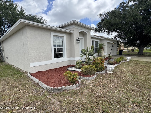 539 Olsmar St SW, Palm Bay, FL 32908 - single story home with an attached garage, stucco siding, driveway, and a front lawn
