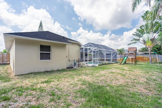 4920 48th Pl, Vero Beach, FL 32967 - view of yard with a playground and glass enclosure