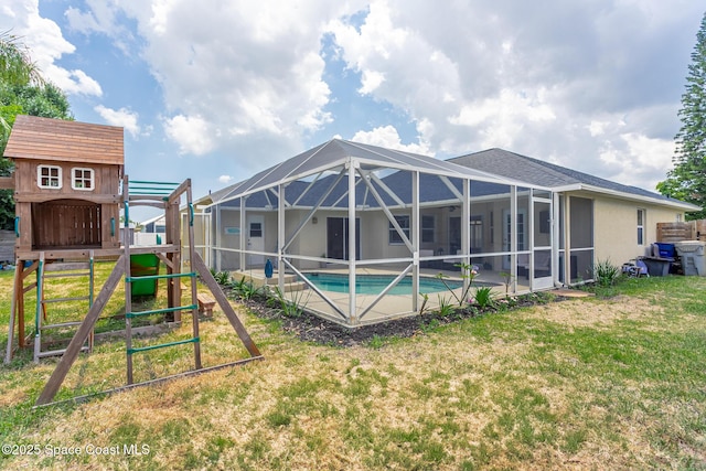 4920 48th Pl, Vero Beach, FL 32967 - back of property featuring an outdoor pool, a playground, a yard, and a lanai