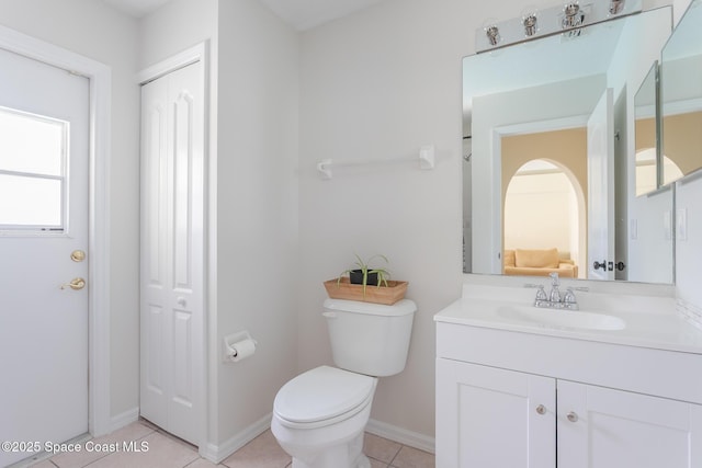 4920 48th Pl, Vero Beach, FL 32967 - bathroom featuring toilet, vanity, tile patterned floors, and baseboards