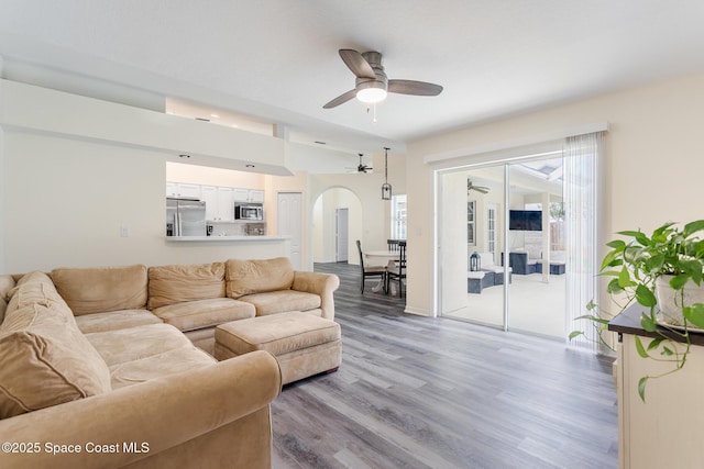 4920 48th Pl, Vero Beach, FL 32967 - living area with arched walkways, a ceiling fan, and wood finished floors