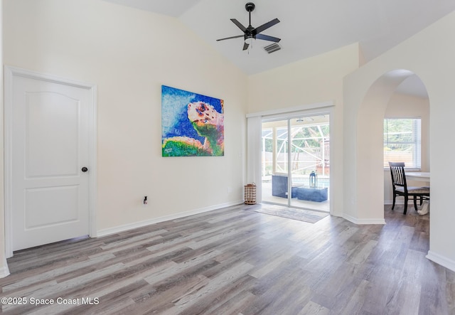 4920 48th Pl, Vero Beach, FL 32967 - unfurnished room with high vaulted ceiling, a ceiling fan, wood finished floors, arched walkways, and baseboards