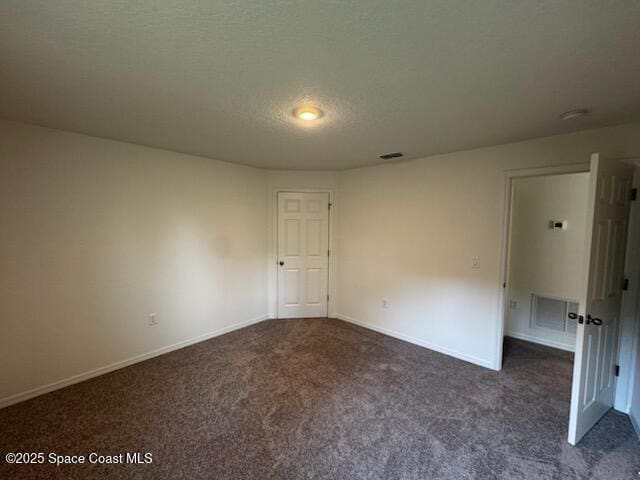 2995 Wilkinson Ave SE, Palm Bay, FL 32909 - carpeted empty room with baseboards and a textured ceiling