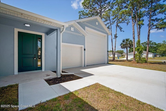 998 Wacona St SE, Palm Bay, FL 32909 - exterior space featuring concrete driveway, an attached garage, and stucco siding