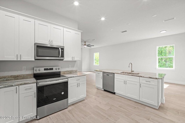 998 Wacona St SE, Palm Bay, FL 32909 - kitchen featuring stainless steel appliances, a sink, ceiling fan, white cabinetry, and recessed lighting