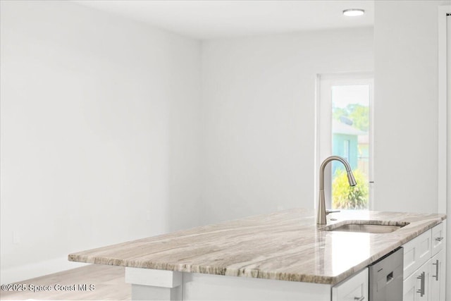 998 Wacona St SE, Palm Bay, FL 32909 - kitchen featuring a sink, dishwasher, white cabinets, light stone countertops, and light wood-style floors