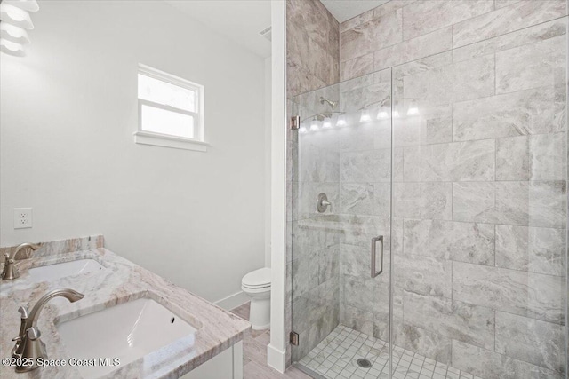998 Wacona St SE, Palm Bay, FL 32909 - full bath featuring a stall shower, toilet, baseboards, and double vanity