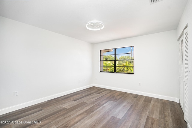 113 Harbor Dr, Cape Canaveral, FL 32920 - unfurnished bedroom with dark wood finished floors and a closet