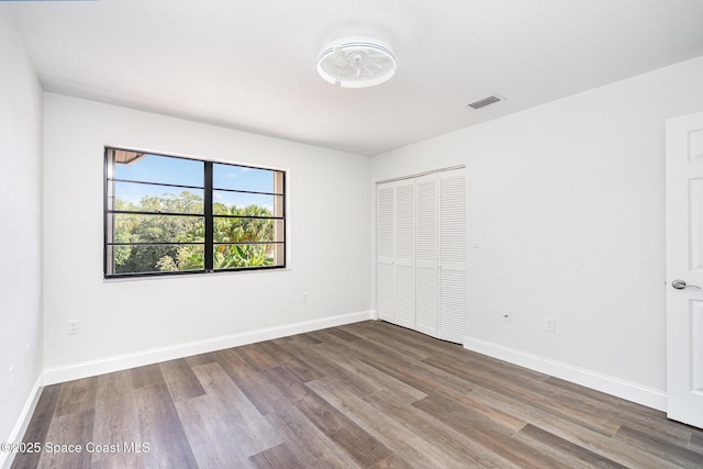 113 Harbor Dr, Cape Canaveral, FL 32920 - unfurnished bedroom featuring wood finished floors and a closet