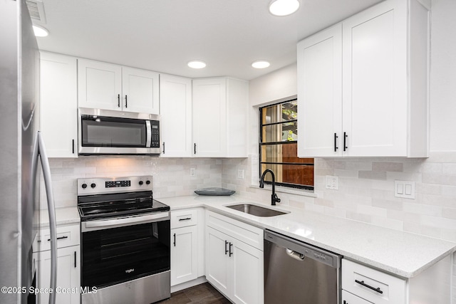 113 Harbor Dr, Cape Canaveral, FL 32920 - kitchen featuring stainless steel appliances, backsplash, white cabinets, and recessed lighting