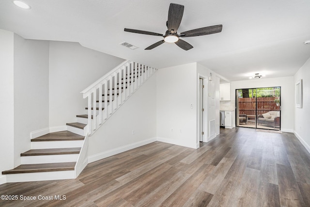 113 Harbor Dr, Cape Canaveral, FL 32920 - unfurnished living room featuring stairway, a ceiling fan, wood finished floors, and recessed lighting
