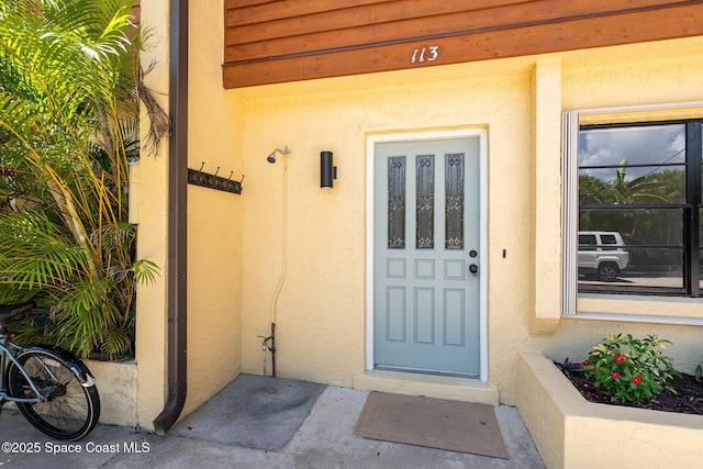 113 Harbor Dr, Cape Canaveral, FL 32920 - property entrance with stucco siding