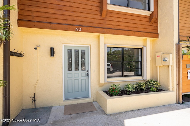 113 Harbor Dr, Cape Canaveral, FL 32920 - doorway to property featuring stucco siding