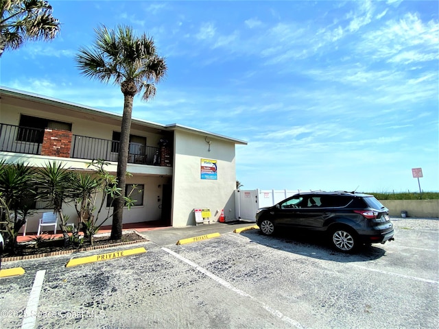 view of building exterior with uncovered parking