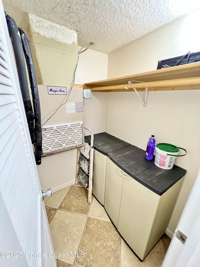 22 Tulip Ave Unit 330, Cocoa Beach, FL 32931 - laundry area featuring a textured ceiling