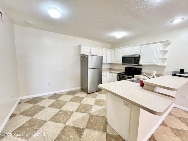 22 Tulip Ave Unit 330, Cocoa Beach, FL 32931 - kitchen featuring stainless steel appliances, a peninsula, a textured ceiling, open shelves, and white cabinets
