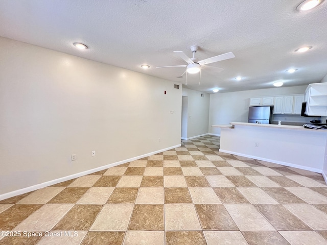 22 Tulip Ave Unit 330, Cocoa Beach, FL 32931 - unfurnished living room with a ceiling fan, a textured ceiling, and recessed lighting