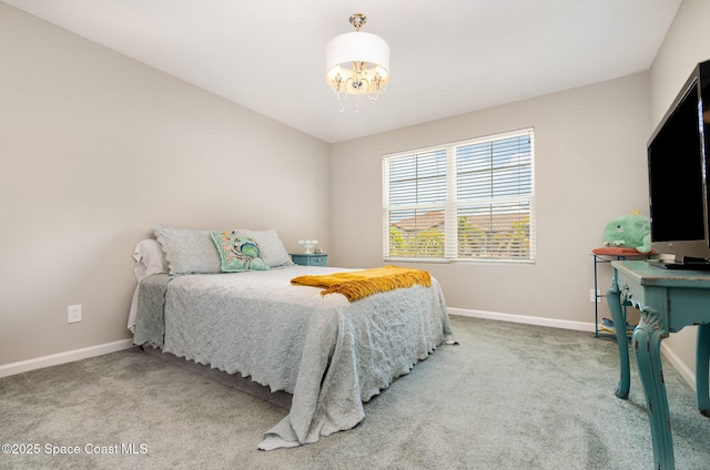 bedroom with a chandelier, baseboards, and carpet
