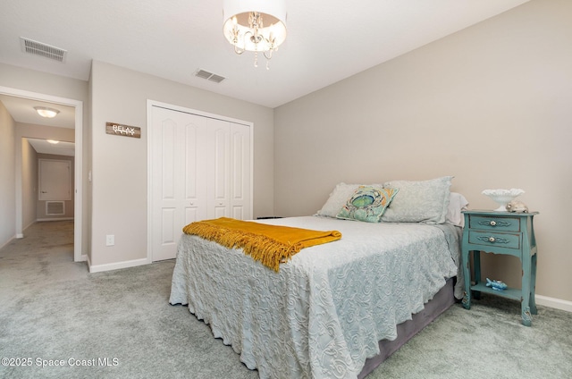 bedroom featuring light carpet, baseboards, a closet, and a chandelier