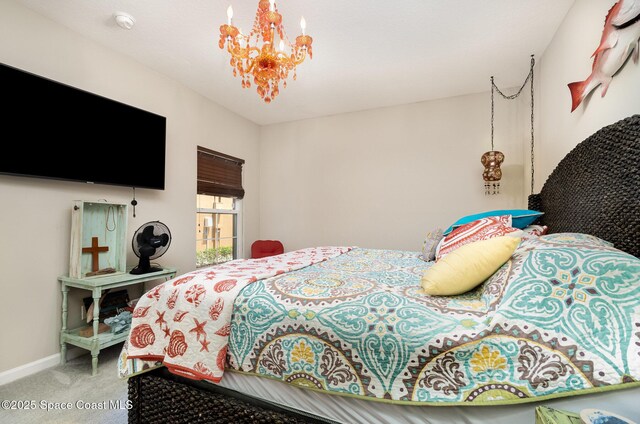 bedroom with carpet, a chandelier, and baseboards