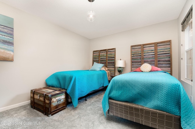 bedroom with carpet flooring and baseboards