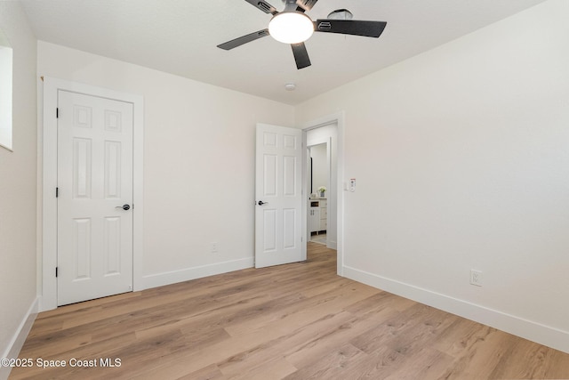 225 Price Ct, Satellite Beach, FL 32937 - unfurnished bedroom featuring baseboards, light wood finished floors, and a ceiling fan