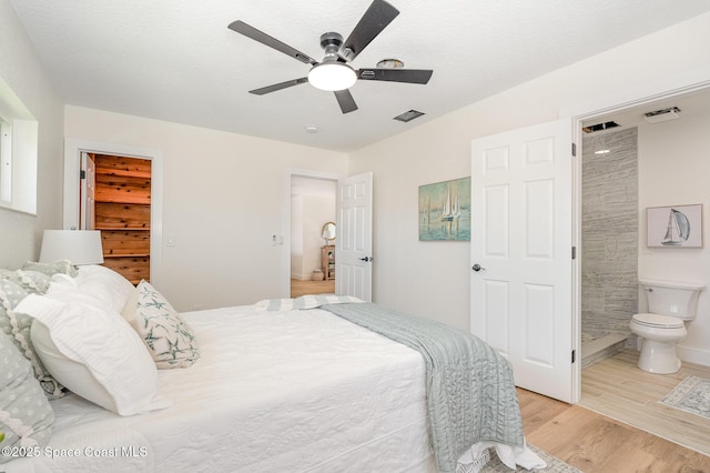 225 Price Ct, Satellite Beach, FL 32937 - bedroom featuring light wood-style flooring, ensuite bathroom, a spacious closet, and ceiling fan