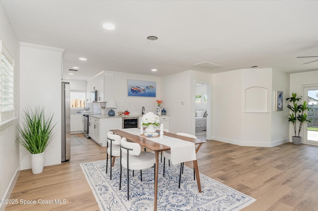 225 Price Ct, Satellite Beach, FL 32937 - dining room with light wood-style flooring, baseboards, recessed lighting, and beverage cooler