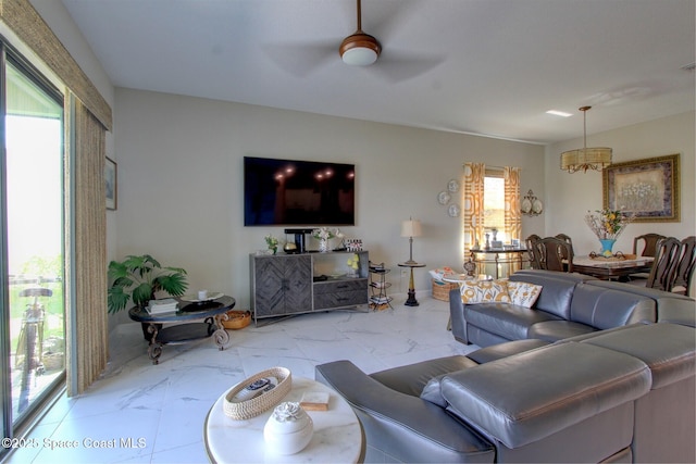 2242 Great Belt Cir, Melbourne, FL 32940 - living area with marble finish floors, ceiling fan, and a chandelier