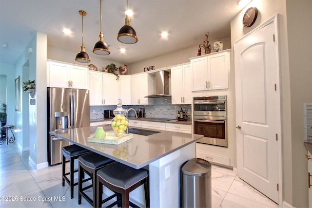 2242 Great Belt Cir, Melbourne, FL 32940 - kitchen featuring appliances with stainless steel finishes, wall chimney exhaust hood, a sink, light marble finish flooring, and decorative backsplash