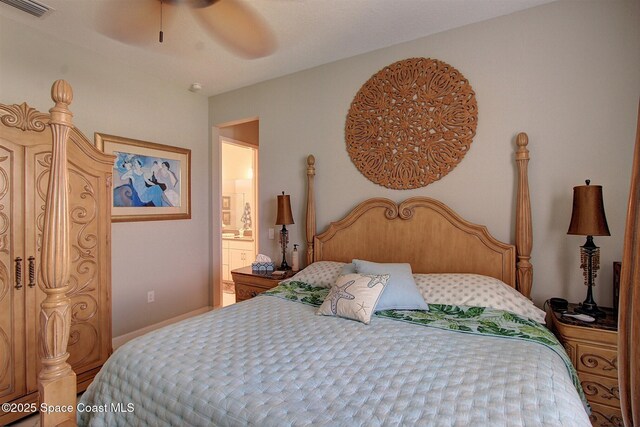 2242 Great Belt Cir, Melbourne, FL 32940 - bedroom with ensuite bath and a ceiling fan