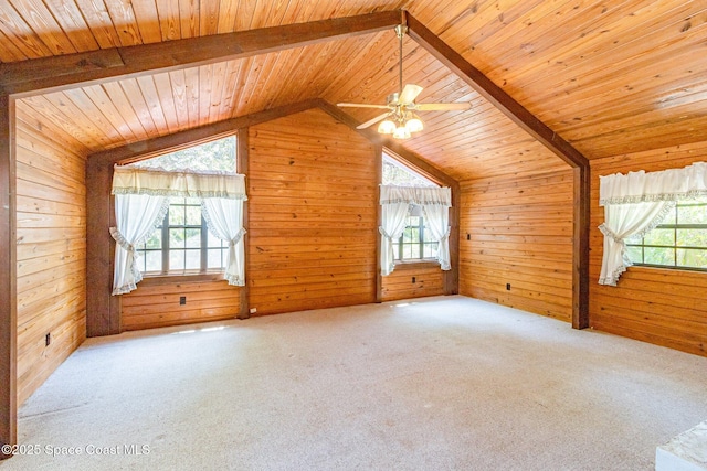 bonus room featuring wood walls, lofted ceiling, wood ceiling, carpet floors, and ceiling fan