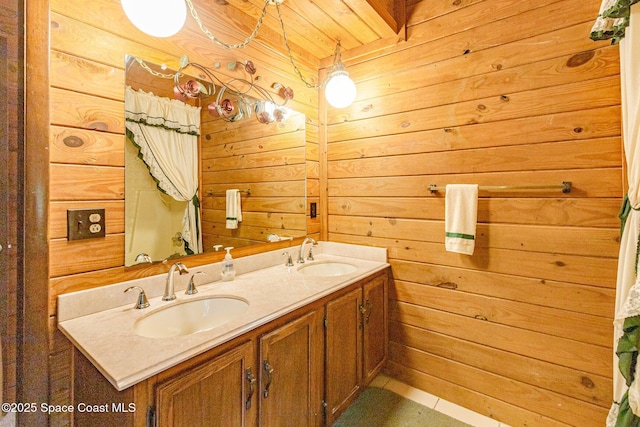 bathroom with wood walls, double vanity, and tile patterned flooring