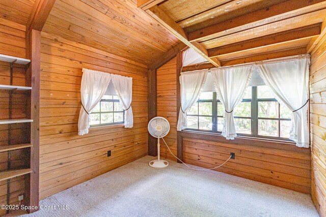 unfurnished room with wooden walls, lofted ceiling, carpet, and wood ceiling