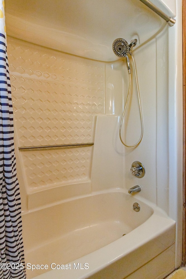 bathroom with shower / bath combo with shower curtain