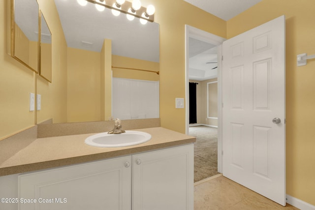 full bath featuring vanity, baseboards, and tile patterned flooring