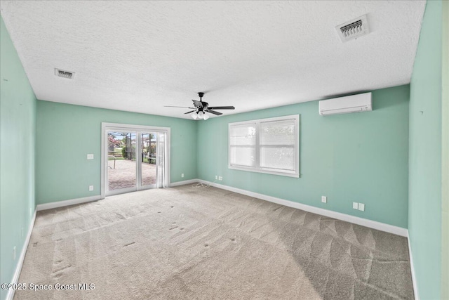 6345 Anchor Ln, Rockledge, FL 32955 - carpeted empty room featuring a wall mounted air conditioner, ceiling fan, baseboards, and a textured ceiling