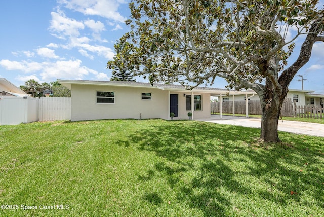 878 Iroquois Ave, Melbourne, FL 32935 - back of house with stucco siding, driveway, a patio area, and a carport