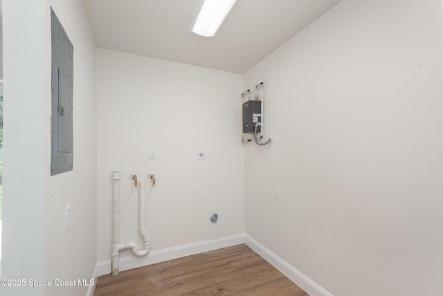878 Iroquois Ave, Melbourne, FL 32935 - laundry room featuring electric dryer hookup, light wood finished floors, baseboards, and electric panel