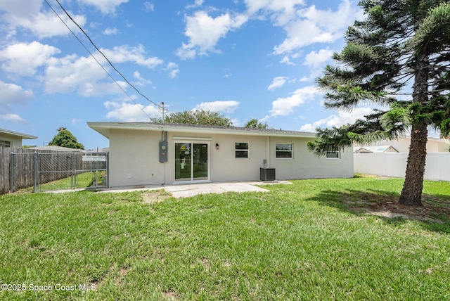 878 Iroquois Ave, Melbourne, FL 32935 - back of house with stucco siding, central air condition unit, and a patio area