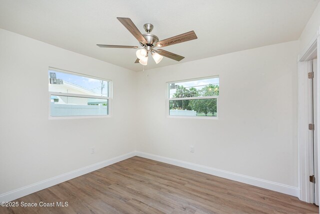 878 Iroquois Ave, Melbourne, FL 32935 - unfurnished room with healthy amount of natural light, light wood-style flooring, baseboards, and a ceiling fan