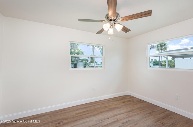878 Iroquois Ave, Melbourne, FL 32935 - spare room featuring plenty of natural light, baseboards, wood finished floors, and ceiling fan