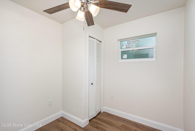 878 Iroquois Ave, Melbourne, FL 32935 - unfurnished bedroom with a closet, wood finished floors, baseboards, and ceiling fan