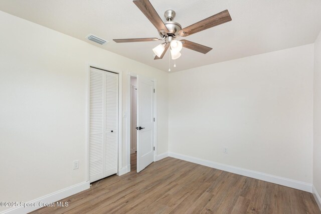 878 Iroquois Ave, Melbourne, FL 32935 - unfurnished bedroom featuring baseboards, light wood-type flooring, a closet, and ceiling fan