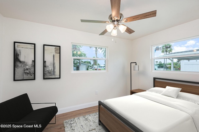 878 Iroquois Ave, Melbourne, FL 32935 - bedroom featuring wood finished floors, baseboards, and a ceiling fan