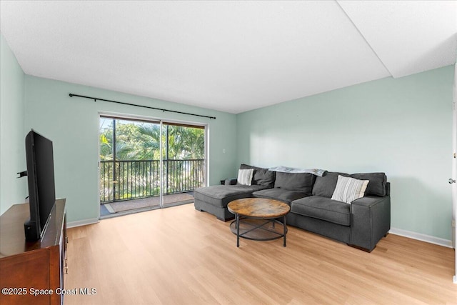 living room featuring light wood-style flooring and baseboards
