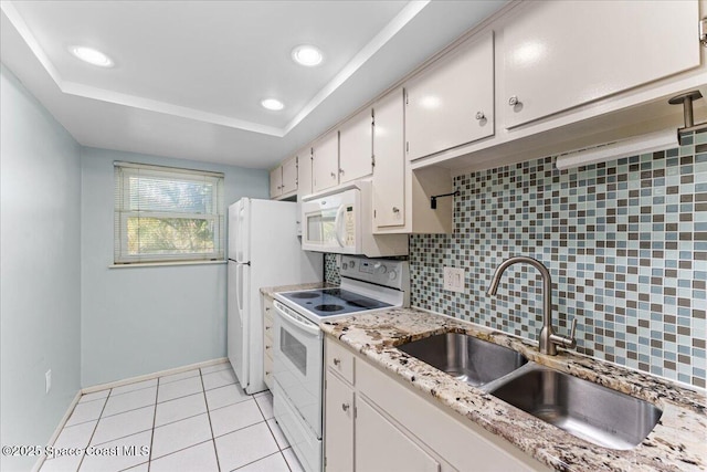 kitchen featuring white appliances, a sink, backsplash, light tile patterned floors, and recessed lighting