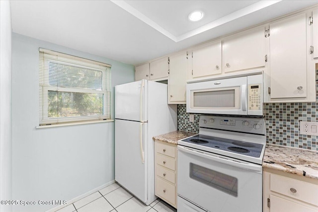 kitchen with white appliances, backsplash, light tile patterned flooring, and baseboards